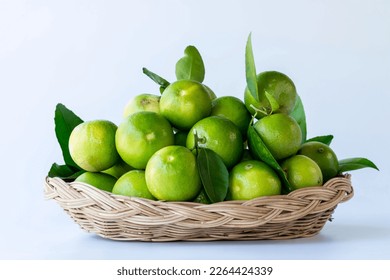 Fresh green oranges in basket , Fresh green oranges at market and shop for sell.Fresh green lemons, in basket , Fresh green lemons at market and shop for sell. - Shutterstock ID 2264424339