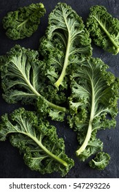 Fresh Green Organic Kale Leaves On Dark Background. Top View.