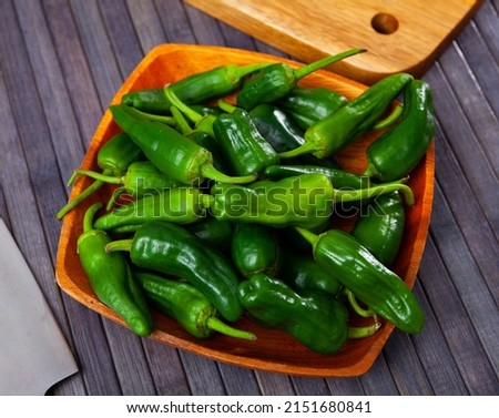 Fresh green padron peppers, spanish pimientos de padron, on table