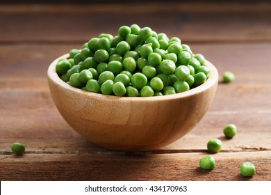 fresh green pea in bowl on wooden background