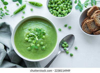 Fresh green pea soup bowl on white  tile background - Powered by Shutterstock