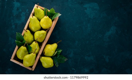 Fresh Green Pear. Assortment Of Pears In A Wooden Box. On The Black Table. Free Space For Text. Top View.