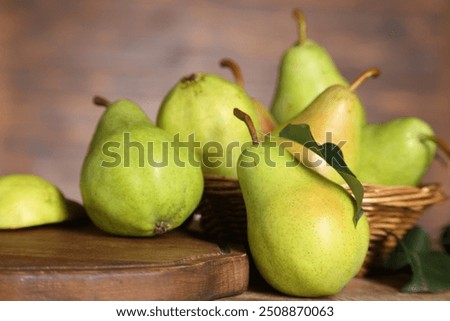 Fresh green pears and leaf on wooden table, closeup
