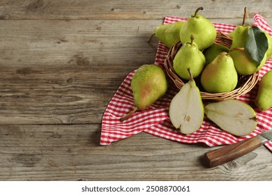 Fresh green pears, wicker basket and napkin on wooden table. Space for text - Powered by Shutterstock