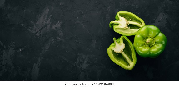 Fresh green pepper in a wooden box. On a black stone background. Top view. Free space for text. - Powered by Shutterstock