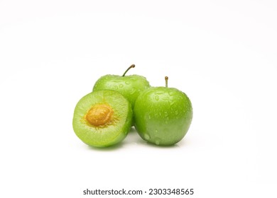 Fresh and green plum on white background