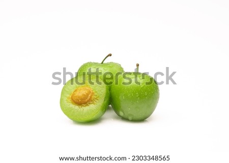Fresh and green plum on white background