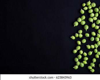 Fresh green podded peas isolated on black background