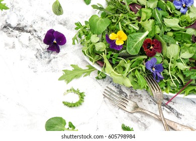 Fresh Green Salad With Herbs And Edible Garden Flowers. Healthy Food. Detox