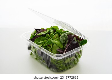 Fresh Green salad in recyclable plastic container on white background - Powered by Shutterstock