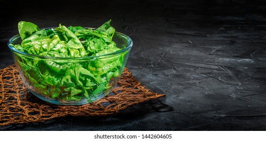 Fresh Green Salad With Spinach In A Glass Bowl On Dark Background