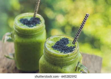 Fresh green smoothie with banana and spinach with heart of sesame seeds. Love for a healthy raw food concept. - Powered by Shutterstock