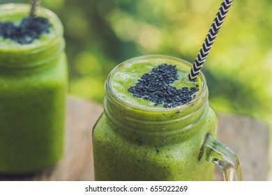 Fresh green smoothie with banana and spinach with heart of sesame seeds. Love for a healthy raw food concept. - Powered by Shutterstock