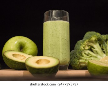 Fresh green smoothie in glass with avocado lime broccoli, apple, cucumber around. Ideal smoothie for wellness, healthy eating, and detox. nutritious ingredients and refreshing taste of this smoothie. - Powered by Shutterstock