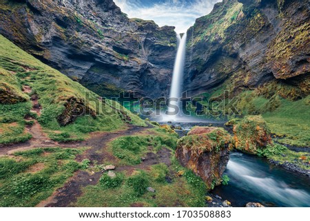 Fresh green view of Kvernufoss watterfall. Splendid summer scene of pure water river in Iceland, Europe. Beauty of nature concept background.