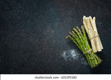 Fresh green and white asparagus on dark background