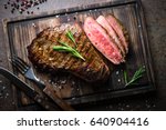 Fresh grilled meat. Grilled beef steak medium rare on wooden cutting board. Top view.