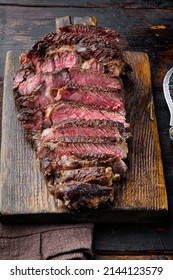 Fresh grilled meat. Grilled beef steak medium rare black angus rib eye steak set, on wooden serving board, on old dark  wooden table background
