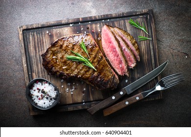 Fresh Grilled Meat. Grilled Beef Steak Medium Rare On Wooden Board. Top View.