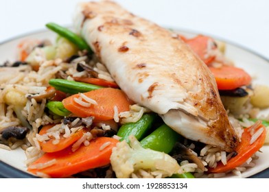 Fresh Grilled Tilapia On Top Of A Vegetable Stirfry