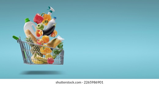 Fresh groceries and goods falling in a supermarket trolley, grocery shopping concept