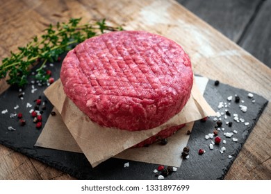 Fresh Ground Premium Beef Burger Cutlets Homemade On Wooden Cutting Board With Salt And Pepper