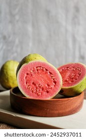 Fresh guava that is split down the middle, so that the inside contents are visible