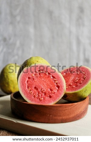 Fresh guava that is split down the middle, so that the inside contents are visible