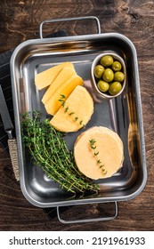 Fresh Halloumi Sliced Cheese In Kitchen Tray With Thyme. Wooden Background. Top View.