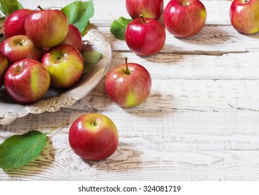 Fresh harvest of apples. Nature theme with red grapes and basket on wooden background. Nature fruit concept. - Powered by Shutterstock