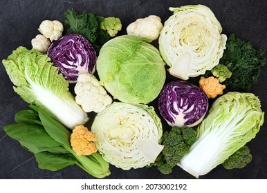 Fresh Harvested Vegetables From Market On Black Background: White, Red And Savoy Cabbage, Broccoli And Colorful Cauliflower, Napa Cabbage And Bok Choy(pak Choi)