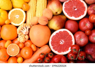 Fresh harvested yellow, red and orange fruits and vegetables from market: corn and orange, tomato and lemon, apple and pear, grapefruit and carrot - Powered by Shutterstock