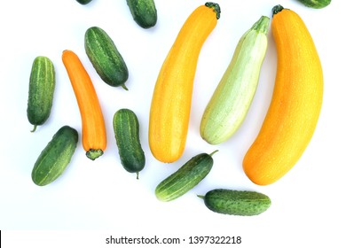 Fresh Harvested Yellow Zucchini Squash And Green Cucumbers On White Background.