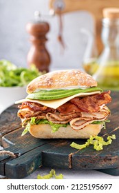 Fresh And Healthy Avocado Turkey Sandwich With Swiss Cheese And Bacon On Chiabatta Roll