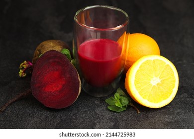 Fresh healthy beetroot and orange smothie in a glass on dark table, top view. Superfoods, detox, diet, healthy food. - Powered by Shutterstock