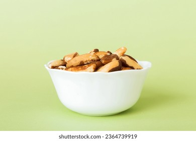 Fresh healthy Brazil nuts in bowl on colored table background. Top view Healthy eating bertholletia concept. Super foods. - Shutterstock ID 2364739919