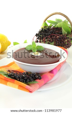 fresh healthy elderberry soup with dollop of whipped cream and mint on a light background Stock photo © 