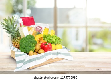 Fresh Healthy Food And Vegetables From Grocery Store In Wood Tray Box On Kitchen Countertop At Home