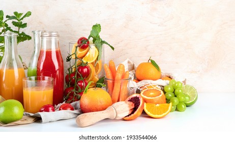 Fresh and healthy home made juices, fruits and vegetables on light wooden background. Copy space