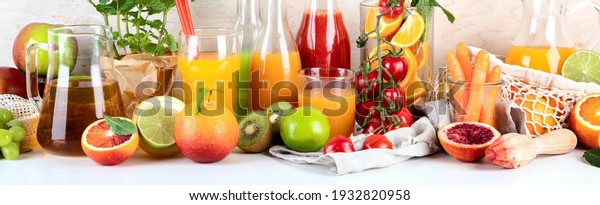Fresh and healthy home made\
juices, fruits and vegetables on light wooden background. Panorama\
banner