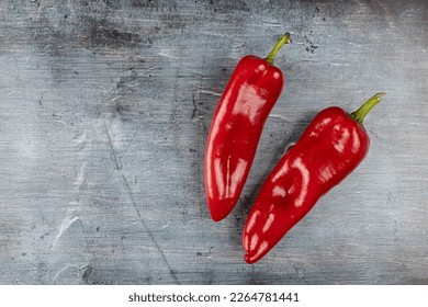Fresh healthy red paprika above blue moody background.