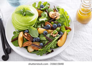 Fresh Healthy Salad With Leafy Greens, Plums, Nuts And Apple