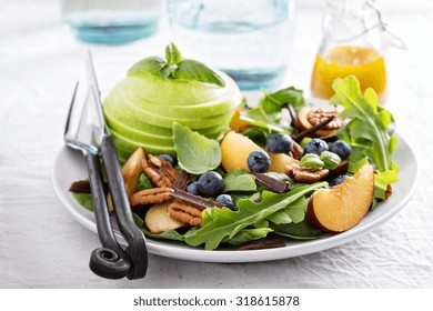 Fresh Healthy Salad With Leafy Greens, Plums, Nuts And Apple