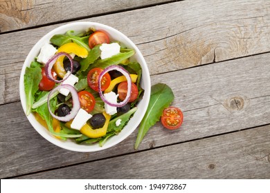 Fresh Healthy Salad On Wooden Table. View From Above With Copy Space