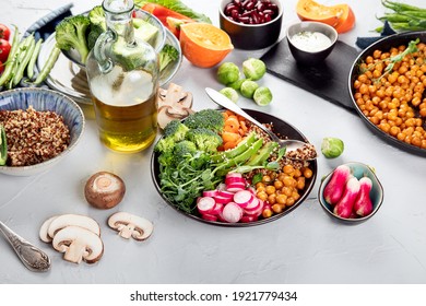Fresh and healthy vegan table with chickpea, buddha bowl, pumpkins, broccoli, quinoa, sprout and other. Light background - Shutterstock ID 1921779434