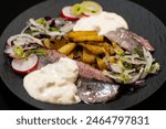 Fresh herb matjes with fried potatoes and Sylt sauce