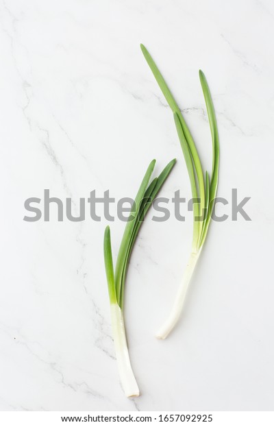 Fresh herbs: Green onion isolated\
on the white background. Fresh Scallions. top view. cooking. close\
up of green aromatic herb for cooking. Chinese\
chive