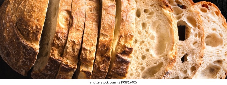 Fresh homebaked artisan sourdough bread. Texture of sliced loaf of bread close up, banner. - Shutterstock ID 2193919405