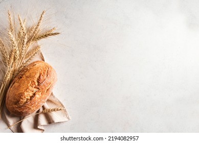 Fresh homebaked artisan sourdough bread. Loaf of bread with ears of wheat on white background, copy space. - Powered by Shutterstock