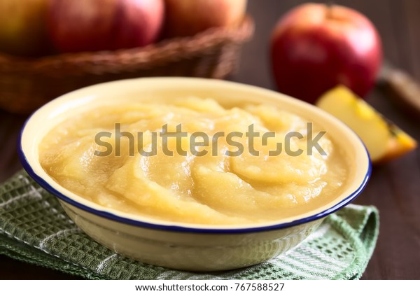 Fresh homemade apple sauce in bowl, photographed\
with natural light (Selective Focus, Focus one third into the apple\
sauce)